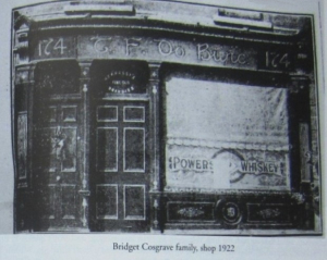 Black and white photo of an old shop front.